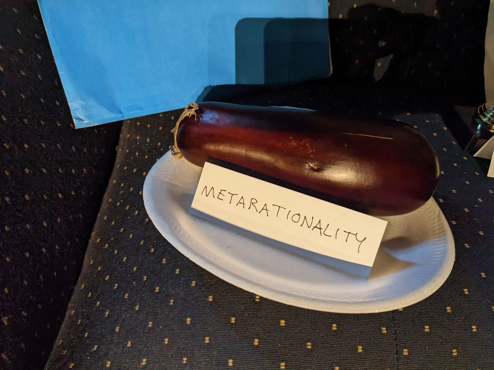 An object on the Ideology Altar with a tent sign labeled Metarationality.