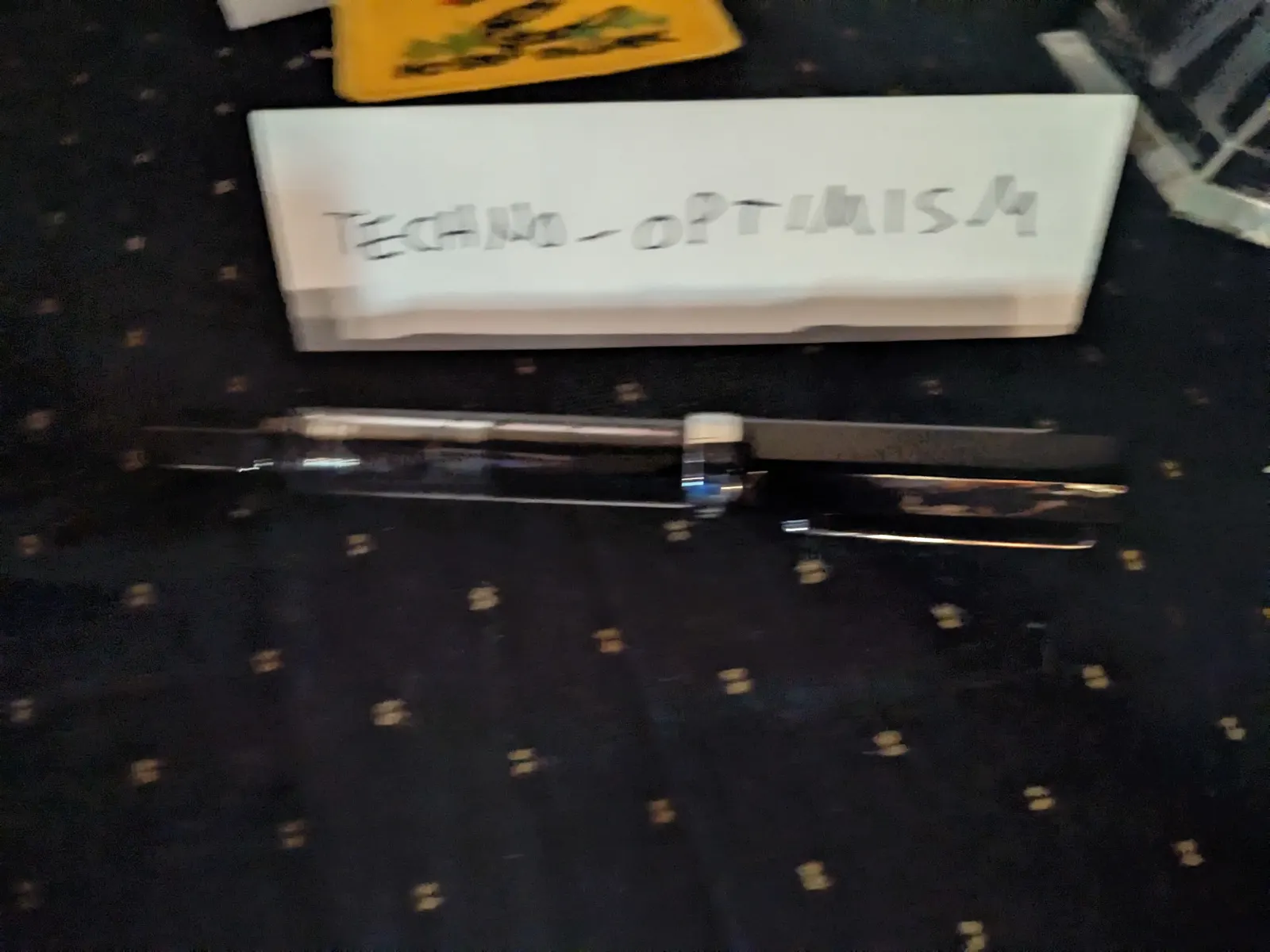 Pens presented as an ideology object beside a labeled tent sign on the Ideology Altar.