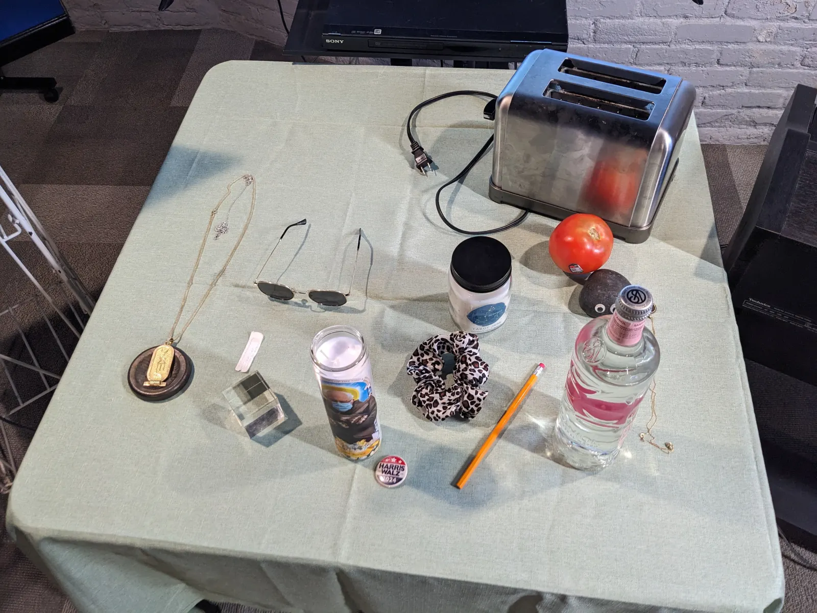 The 2024 Ideology Altar, with participant-contributed objects arranged across a long table.