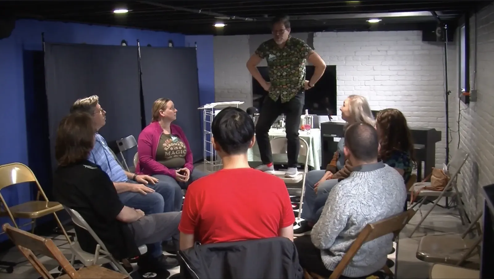 A participant leads an interactive workshop for people seated in a circle.